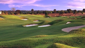 A golf course with sand bunkers and a clear sky. - Luxury Champions Gate Condo, Resort-Style Retreat (Four Corners)