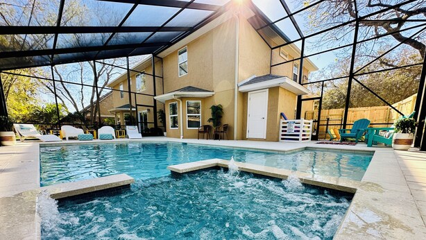 A swimming pool with a house in the background. - 2 LUX homes-1 PERFECT location -14BD/10BA-Heated Pool-WALK to beach-10 min to DT (St. Augustine)