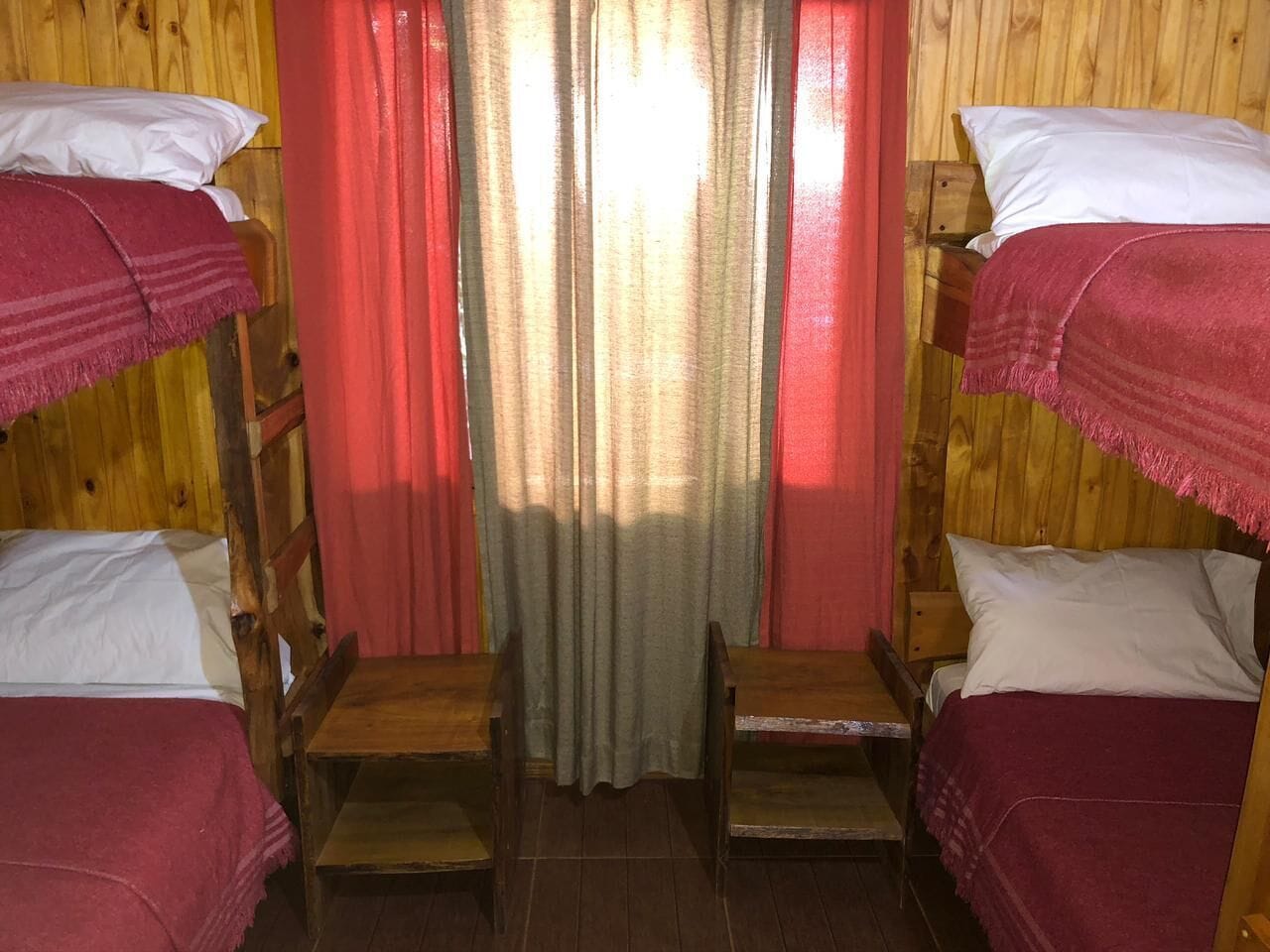 A room with bunk beds and a small table.