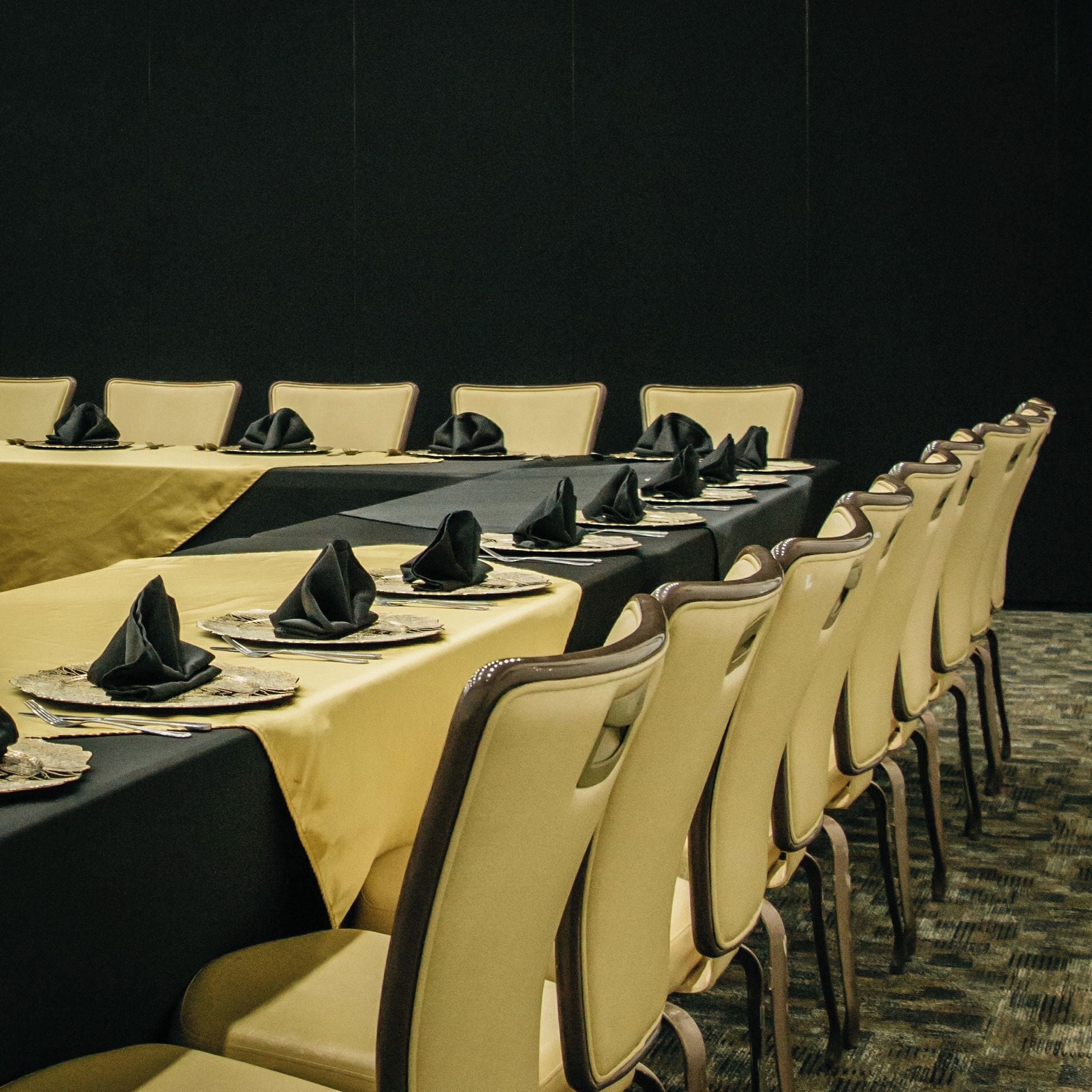 A conference room with long tables set for a meeting.
