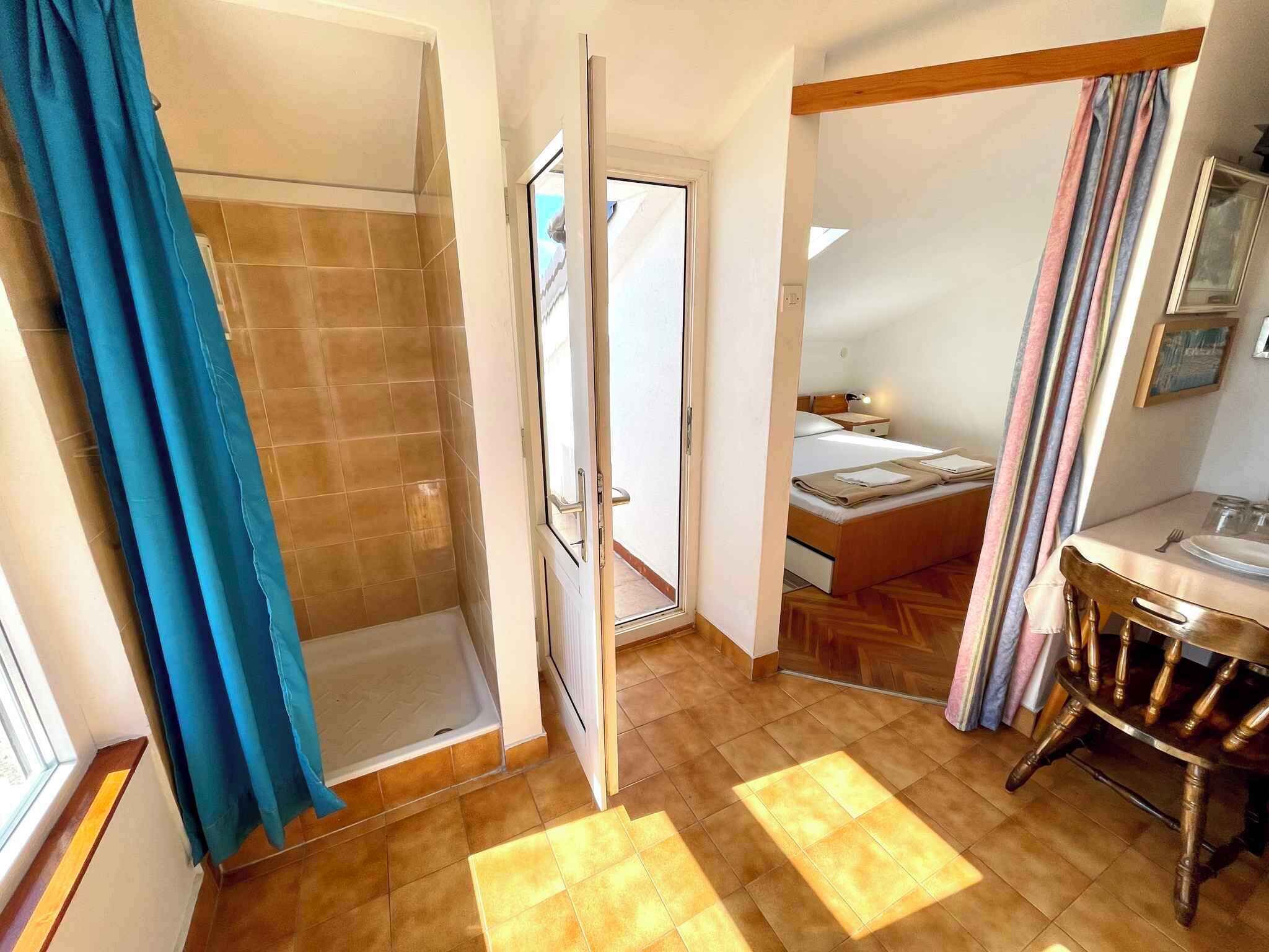 A bathroom with a shower, a toilet, and a sink.