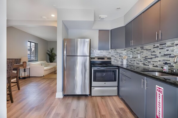 Enjoy cooking in the well-equipped kitchen with a refrigerator, oven, and dining area.