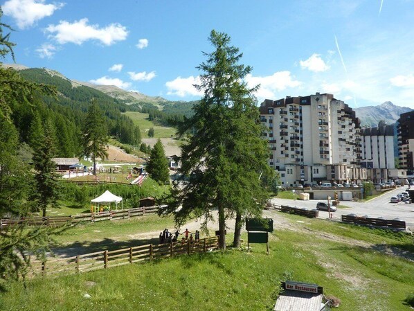 A mountainous area with a bar restaurant and a multi-story building.