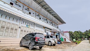 A building with multiple floors, large windows, and a covered upper section. - Hotel O Elisa Hill (Pangkalan Kerinci)