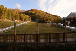 A ski resort with a ski lift, cabins, and a mountain backdrop. - B108 LES Eglantines 1800 (LES ORRES 1800)
