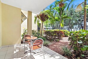 Relax in a tranquil outdoor space surrounded by lush greenery and a serene atmosphere.