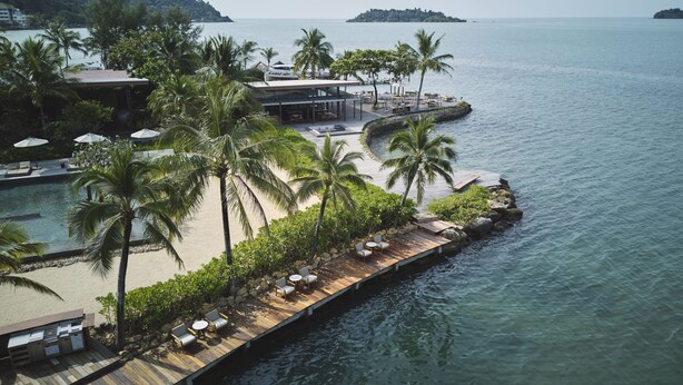 A resort with a wooden deck, palm trees, and a pool. - The Retreat Koh Chang (Ko Chang)