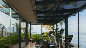 A gym with exercise equipment and a view of the ocean. - The Retreat Koh Chang (Ko Chang)