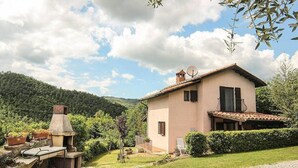 A two-story house with a satellite dish, a chimney, and a small outdoor seating area with a table and chairs. - Casa Binetta A: A characteristic and welcoming two-story independent house situated in the heart of the Tuscan countryside. (Santa Fiora)