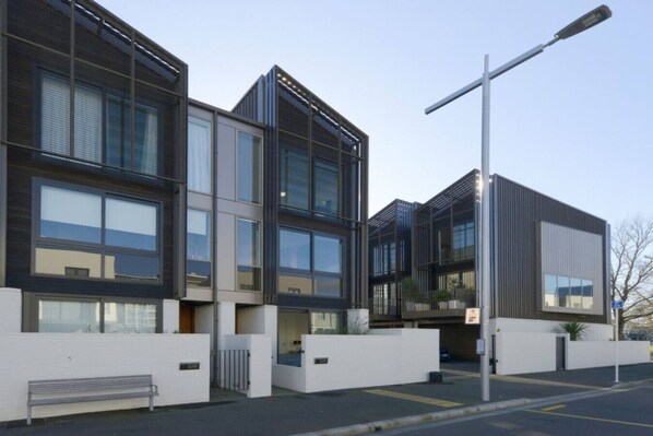 Stylish building with a symmetrical facade, featuring large windows and a minimalist design.