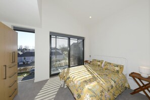 Relax in this serene space with a large bed, a balcony with a view, and a wardrobe for your belongings.