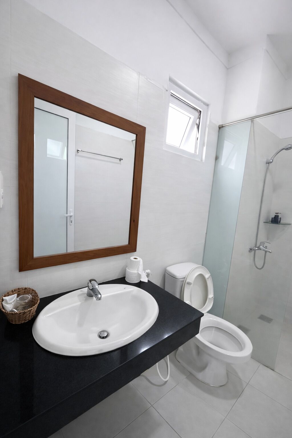A modern bathroom with a sink, toilet, and shower.
