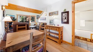 Un salon chaleureux avec une table à manger en bois, un canapé et une cheminée.