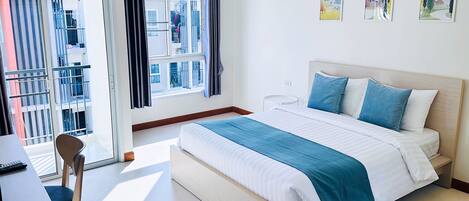 Deluxe Room | Desk, laptop workspace, blackout drapes, iron/ironing board