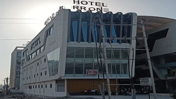 A modern hotel building with a prominent sign reading "HOTEL BRON".