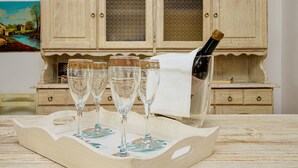 A wooden tray with three glasses and a bottle of champagne on a table. - Holiday Home "Casa Relax Vista Mozzafiato" with Garden & A/C (Cannigione)