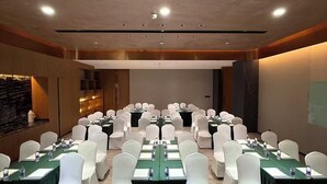 A conference room with multiple tables and chairs, equipped with water bottles and nameplates. - UrCove by Hyatt Nanjing South Railway Station (Nanjing)