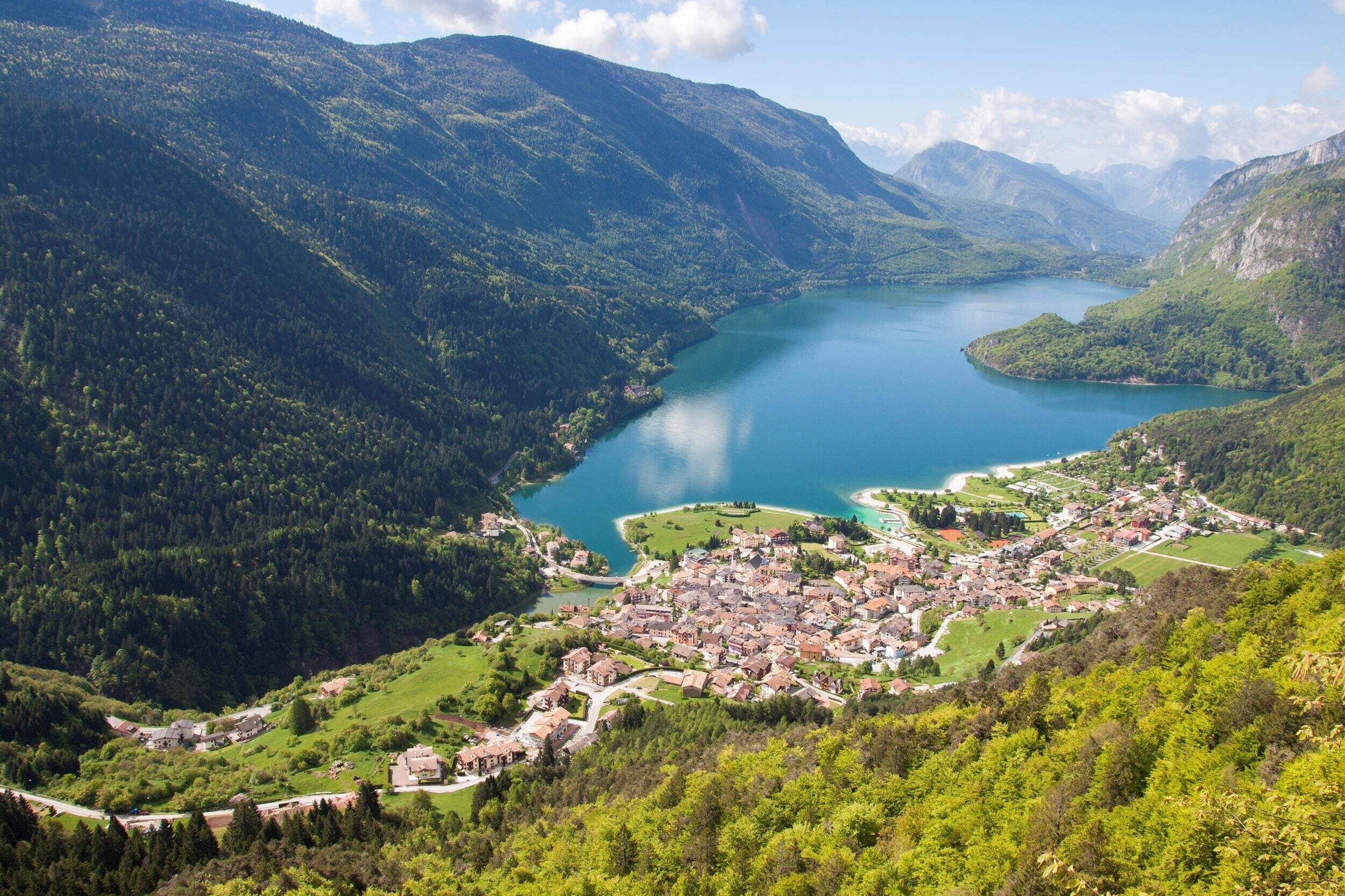 A mountainous landscape with a lake and a town.