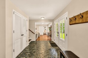 Foyer - brick floors, coat hooks & stairs up to the bedrooms