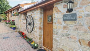 A stone building with a wooden door and a sign that reads "The Hideaway." - The Hideaway (St Austell)