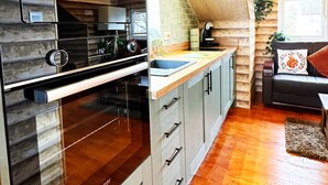 A modern kitchen with a built-in oven, a sink, and a countertop. - Squirrel Hideaway in Formby, Liverpool (Liverpool)