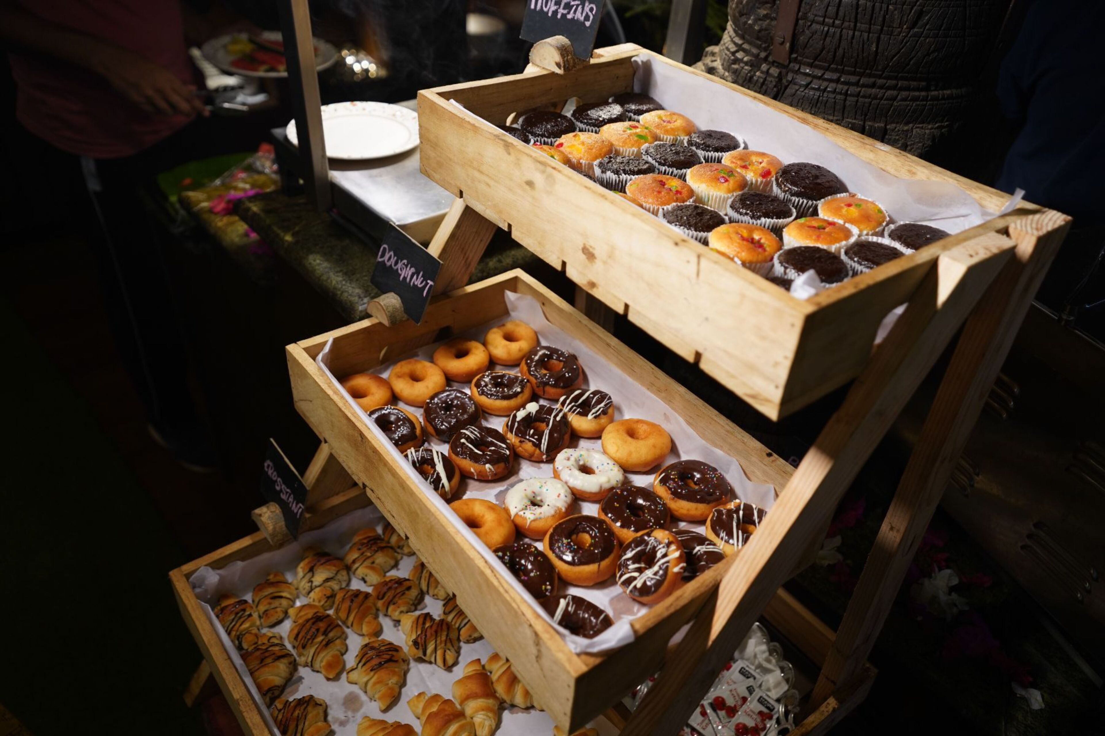 A display of various baked goods in wooden boxes.