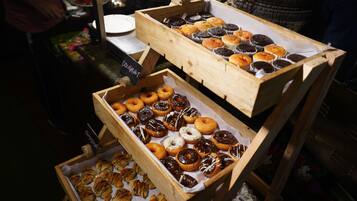 A display of various baked goods in wooden boxes.