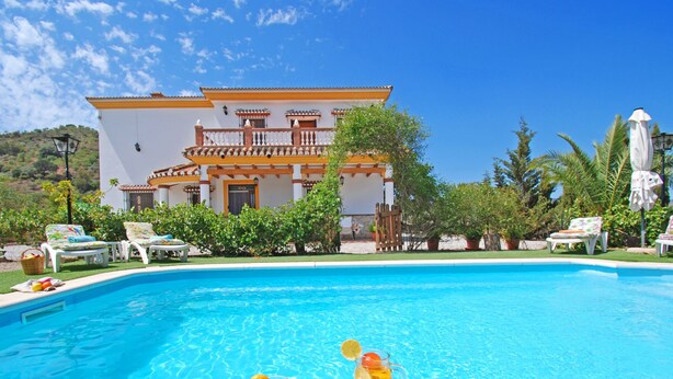 A swimming pool with lounge chairs and a house in the background. - A captivating retreat with pool for an exceptional group holiday. Pet friendly. (Comares)