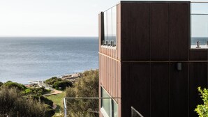 A modern building with a view of the ocean. - The Edge - an architecturally designed home with breathtaking views (Binalong Bay)
