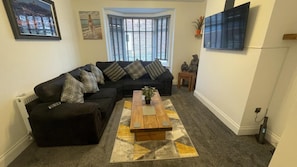 Relax in this inviting space with a sofa, coffee table, and flat-screen TV.