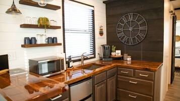 Fridge, microwave, coffee/tea maker, cookware/dishes/utensils