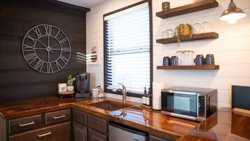 Fridge, microwave, coffee/tea maker, cookware/dishes/utensils