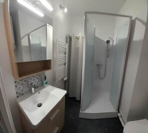 Shower, hair dryer, towels, toilet paper
