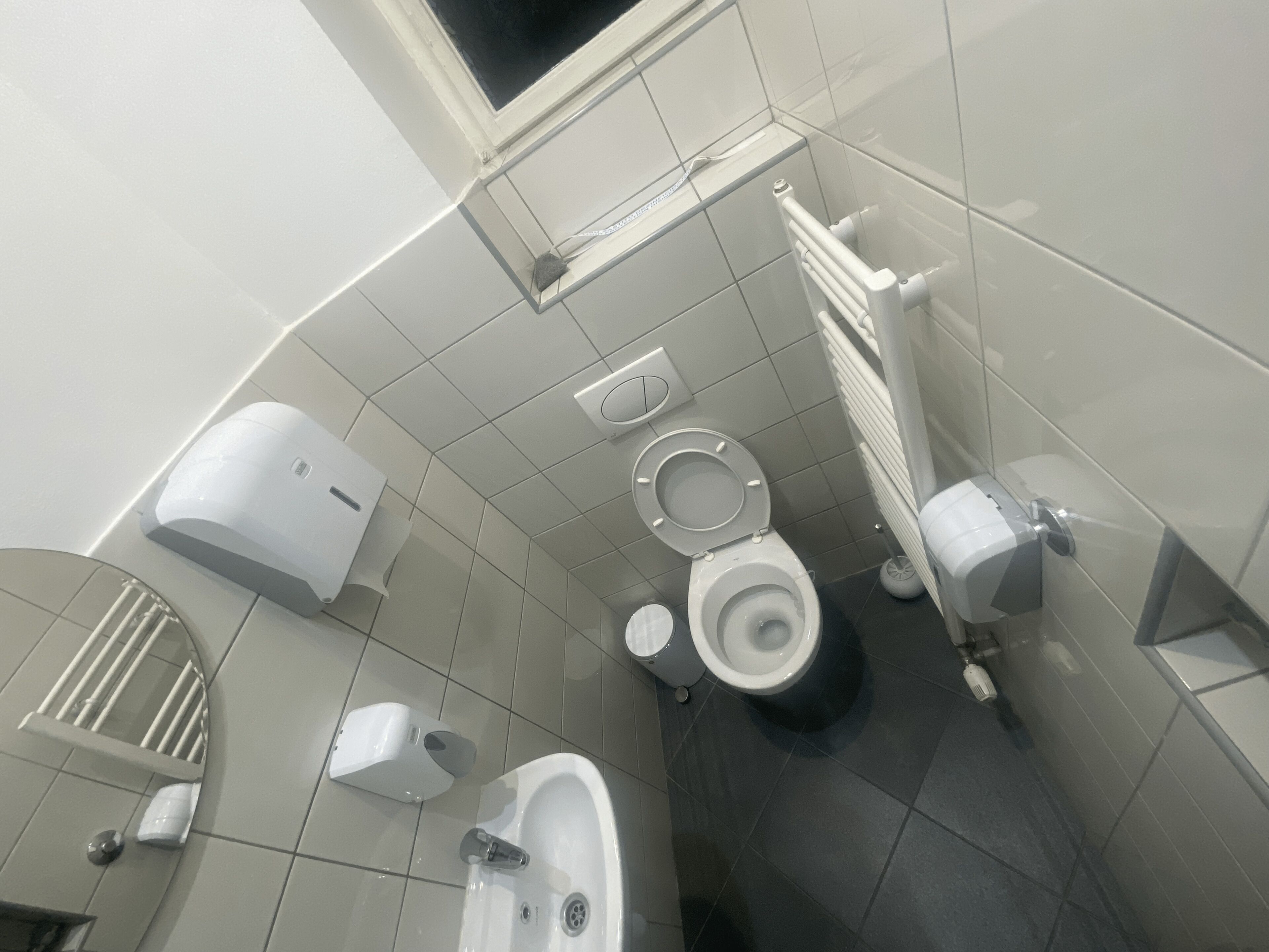 A modern bathroom with a toilet, bidet, and sink.