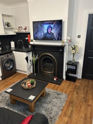 Apartamento, 1 cama Queen e sofá-cama | Área de estar