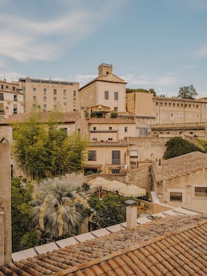 A historic town with traditional architecture, including buildings with terracotta roofs and stone walls.