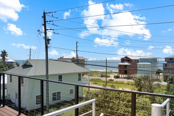 A coastal residential area with houses, a beach, and a clear sky. - Screen Porch, Close to Beach ~ Emerald Palms 3 (St. Joe Beach)