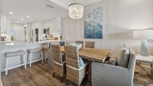 A modern kitchen with white cabinetry, a central island, and a chandelier. - HP 45W What the Heck @ High Pointe | Lagoon Pool | Tennis & Pickleball Courts (High Pointe Resort)