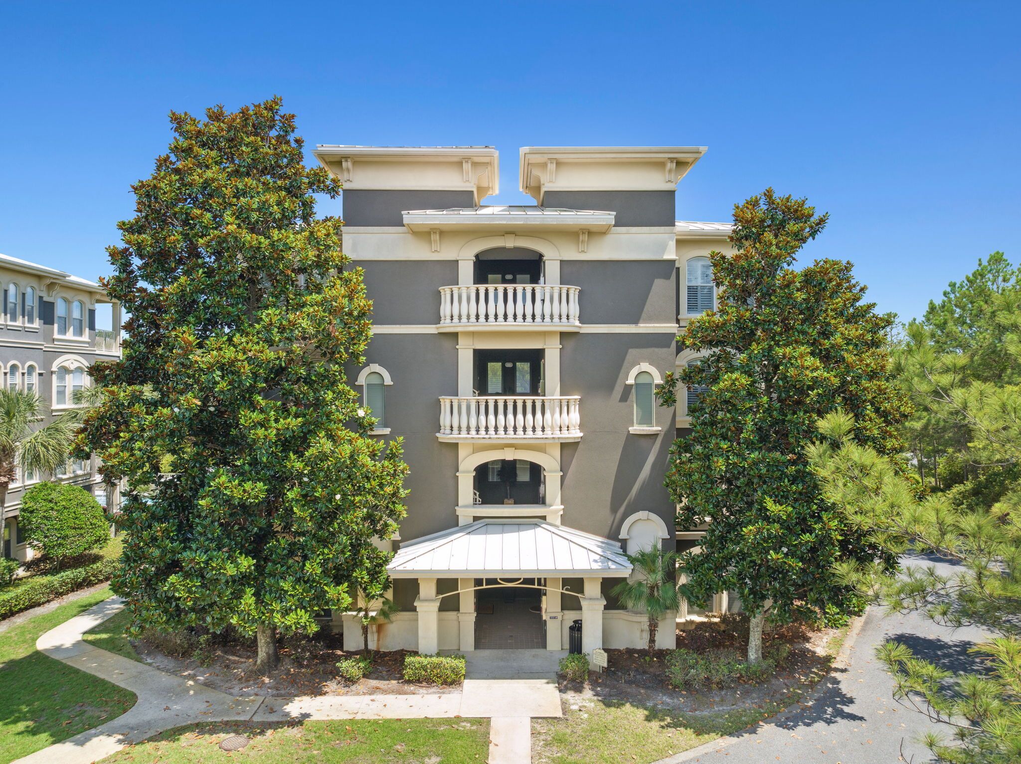 A multi-story building with a symmetrical facade, balconies, and a central entrance.