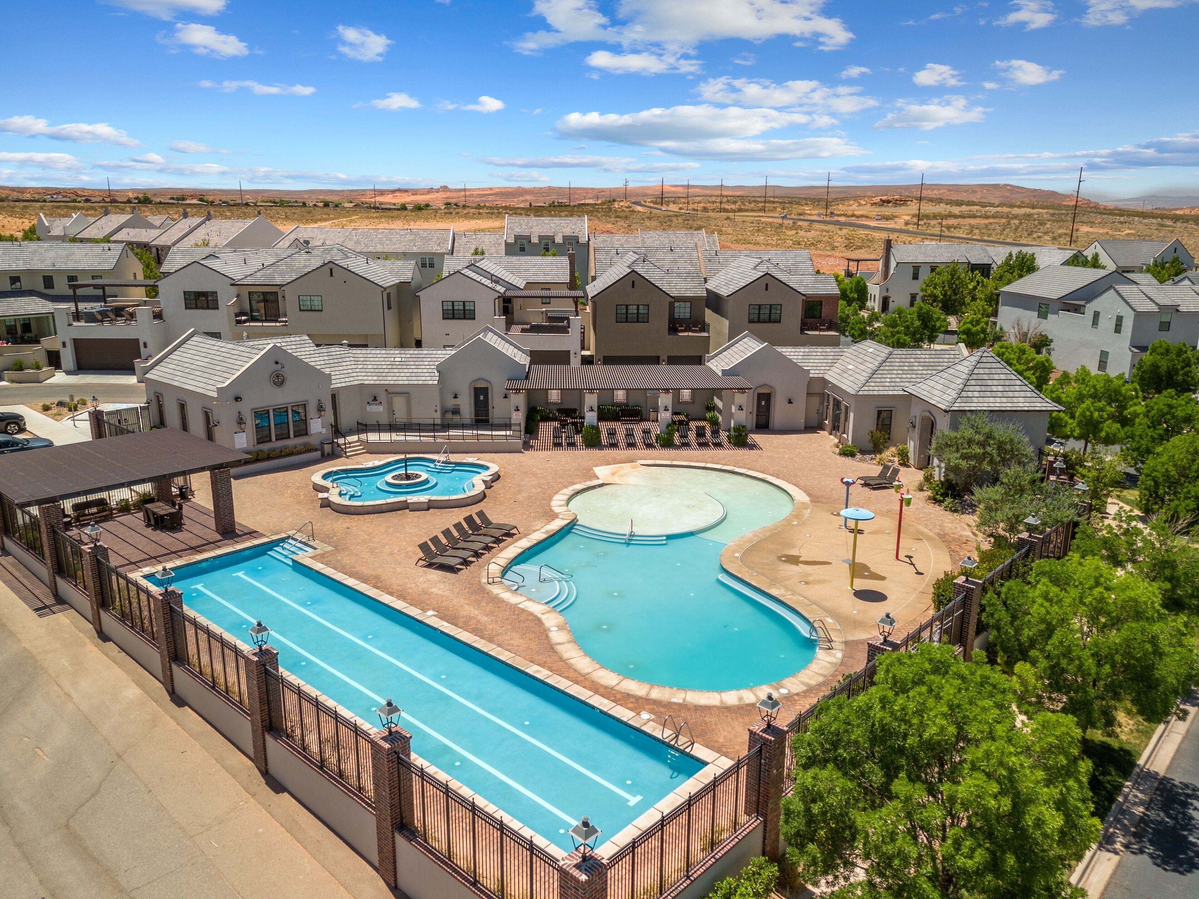 A residential area with multiple houses, a swimming pool, and a landscaped patio area.