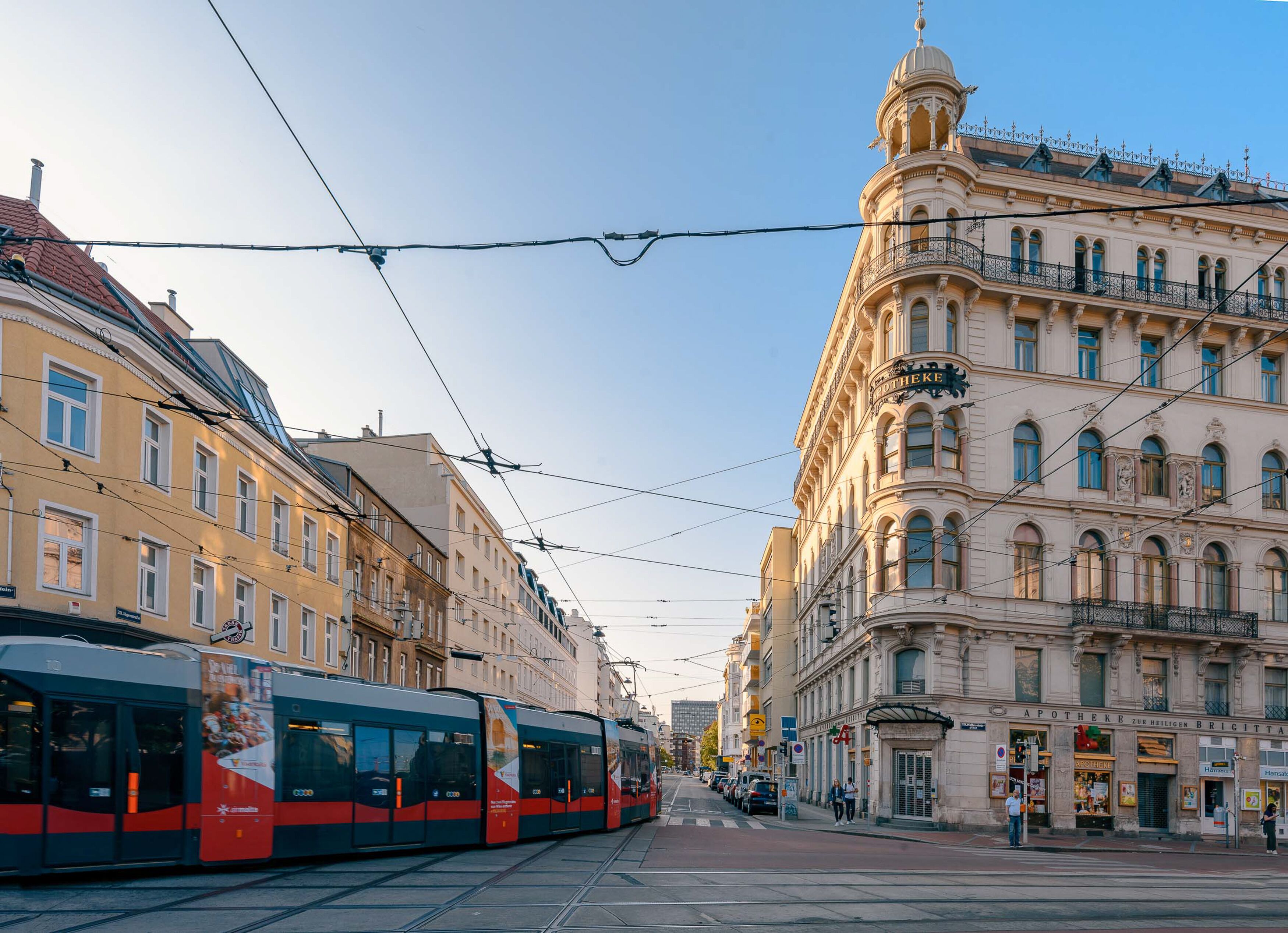A tram line running alongside a historic building with ornate architecture.