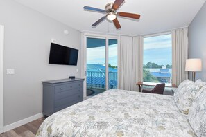 A hotel room with a bed, a television, a ceiling fan, a desk with a chair, and a view of the outside. - 3rd Floor w/ 2 King Beds Near The Elevator at Palms of Destin! (Destin)
