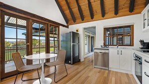 A modern kitchen with a dining area, large windows, and a view of the outdoors. - 'Old Alloway'- 7 Bedrooms/ Sleeps 17 -9mins to CBD (Eglinton)