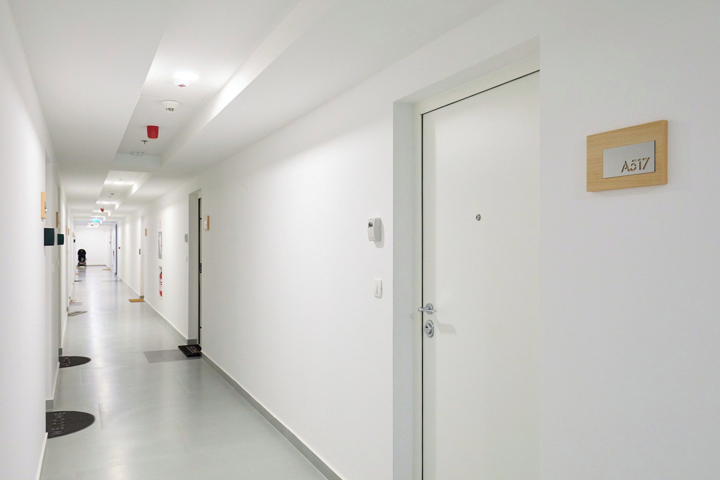 A long, narrow hotel corridor with a door labeled A517.