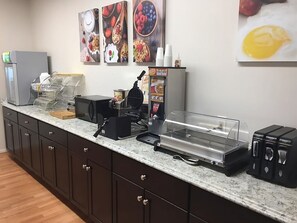 Enjoy cooking and dining in this well-equipped kitchen with a coffee machine, waffle maker, and food display case.