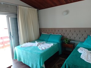 A hotel room with two beds, a wooden ceiling, a window with curtains, and a small bedside table with a plant. - RECANTO VIRGINIA BRACELLI (Campos do Jordão)