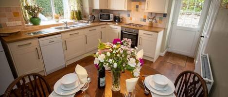 A modern kitchen with a dining area set for a meal.