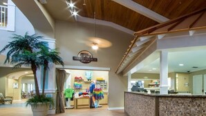 A reception area with a counter, a sign for 'Mareplace', and a 'Holiday Club Vacations' poster.
