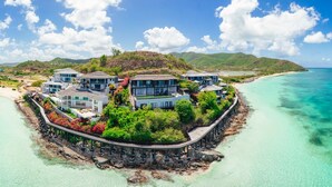 A coastal property with multiple buildings, a pier, and a beach. - Tamarind Hills Resort - Ocean Azul (Antigua and Barbuda)