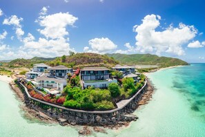 A coastal property with multiple buildings, a pier, and a beach. - Tamarind Hills Resort - Ocean Azul (Antigua and Barbuda)